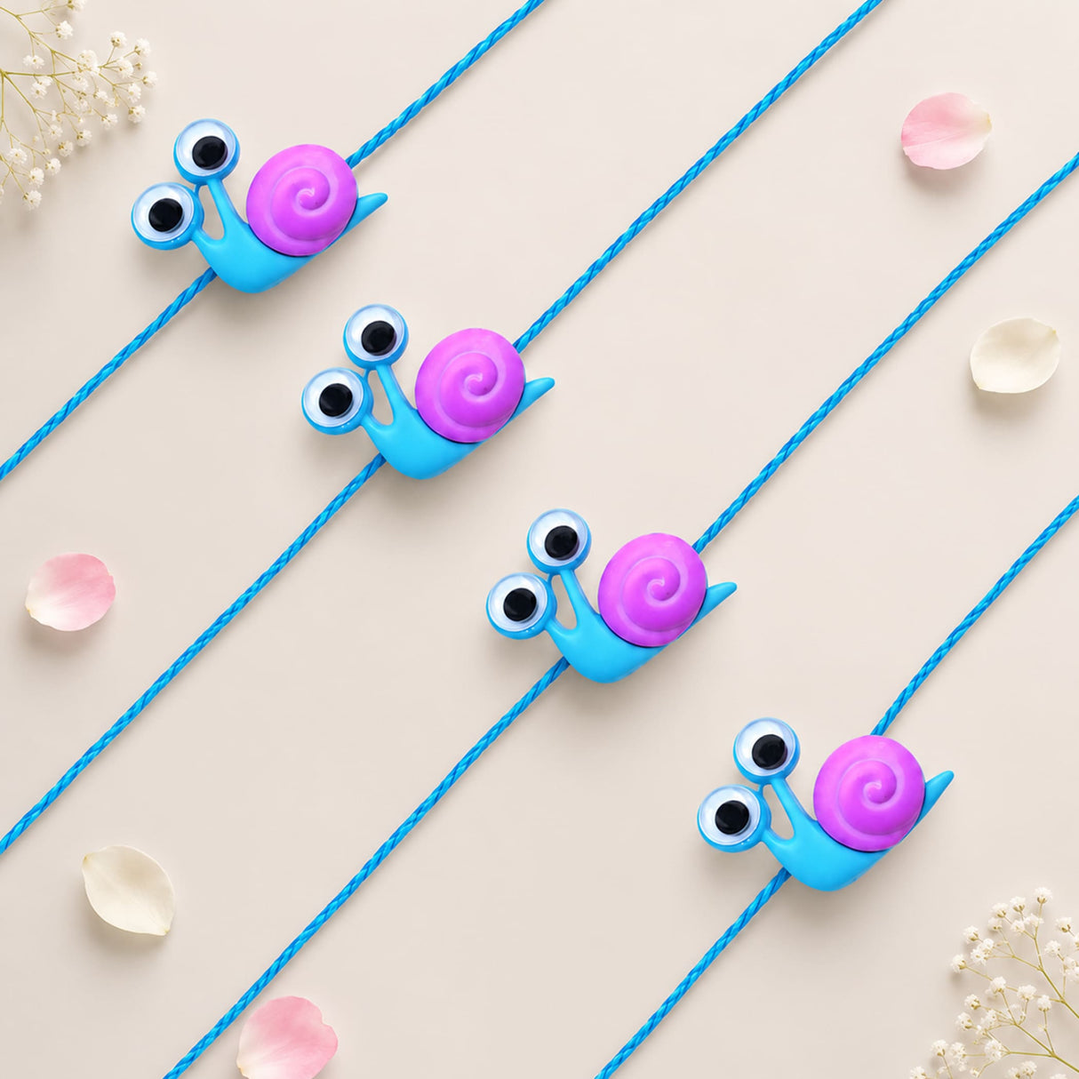 Cute blue and purple snail-shaped phone strap charms with black and white googly eyes from cartoon animal rakhi for kids set