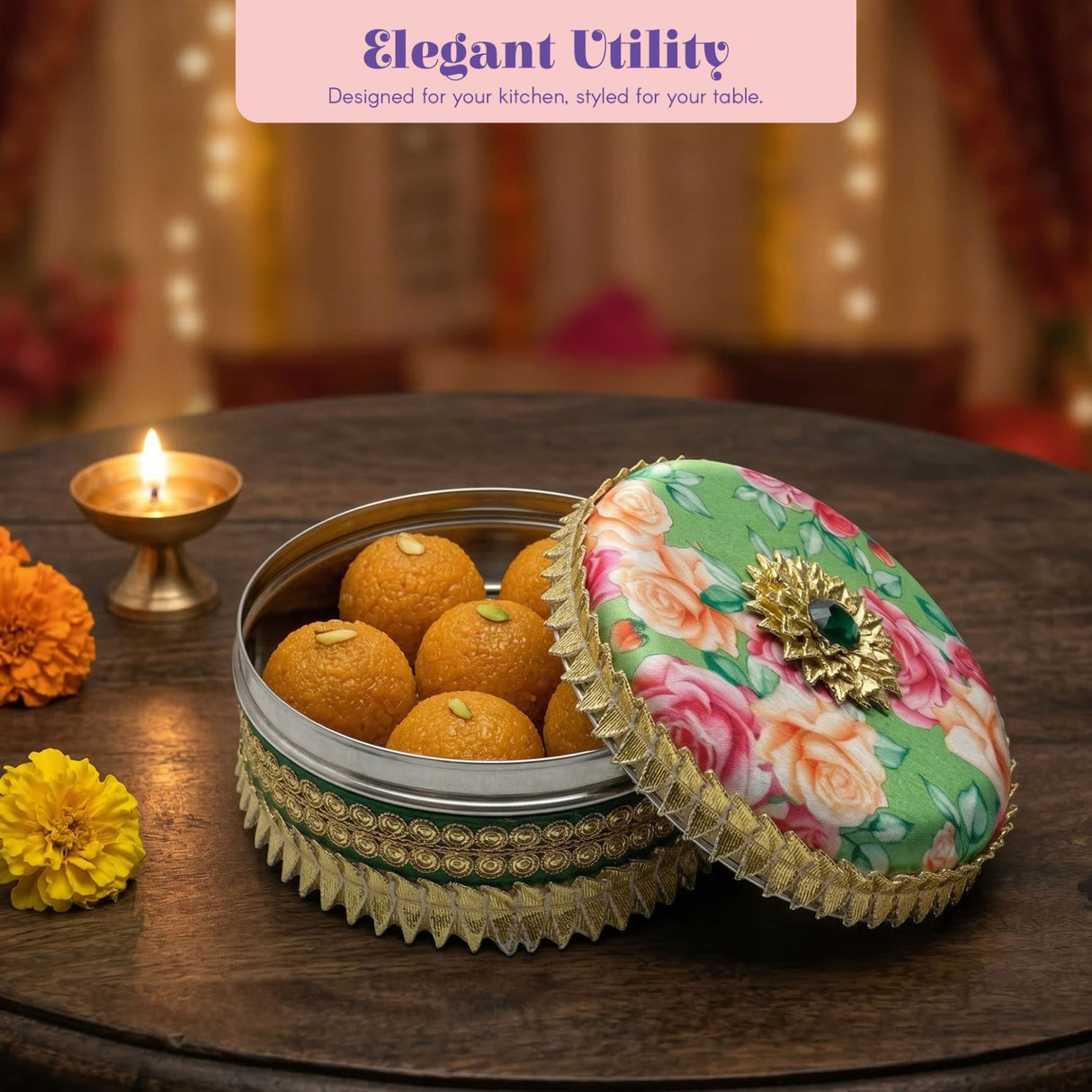 Green floral lid with gold trim and gem on Gotta steel ladoo box of golden sweets