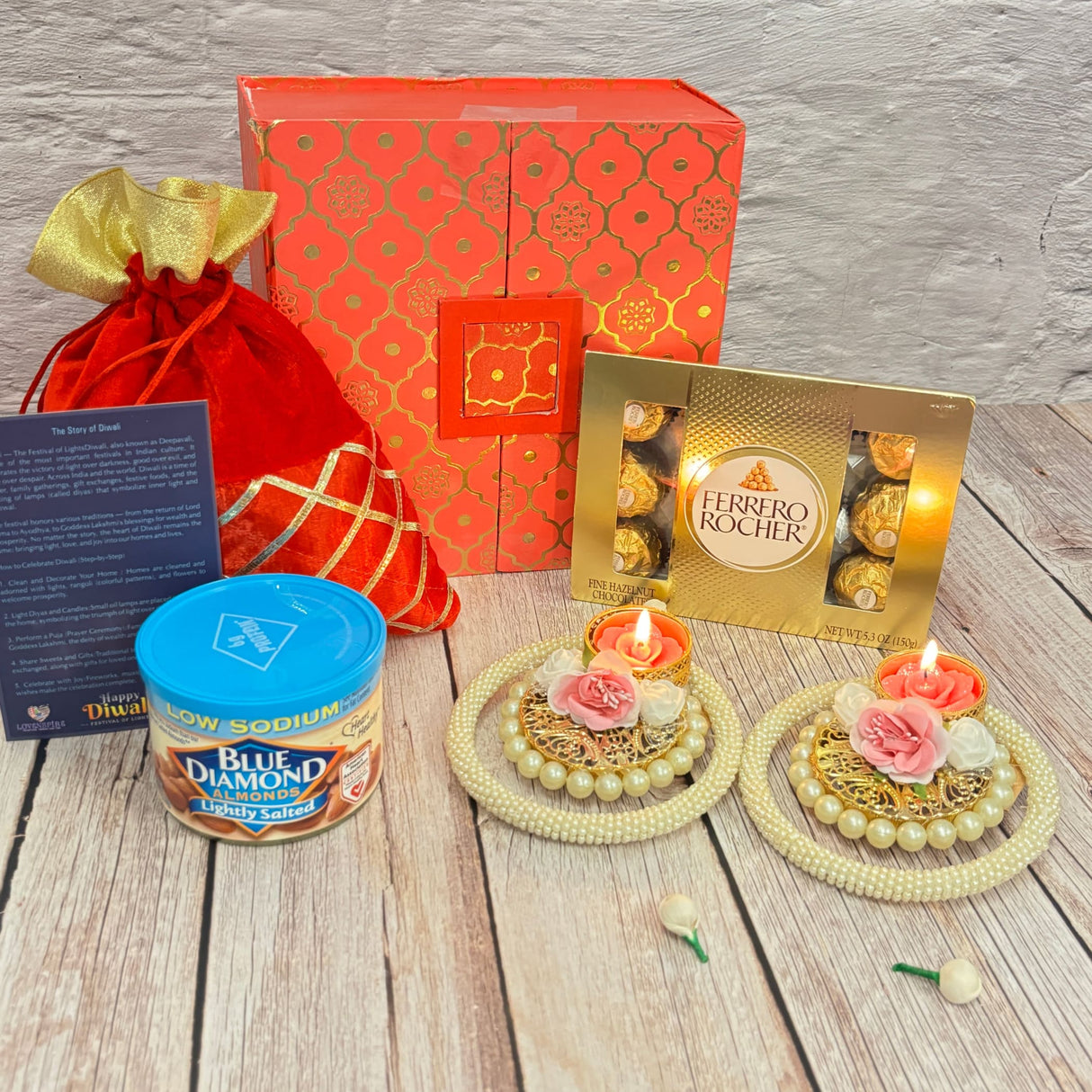 Festive Diwali gift hamper with decorative box, red pouch, almonds, chocolates, candles