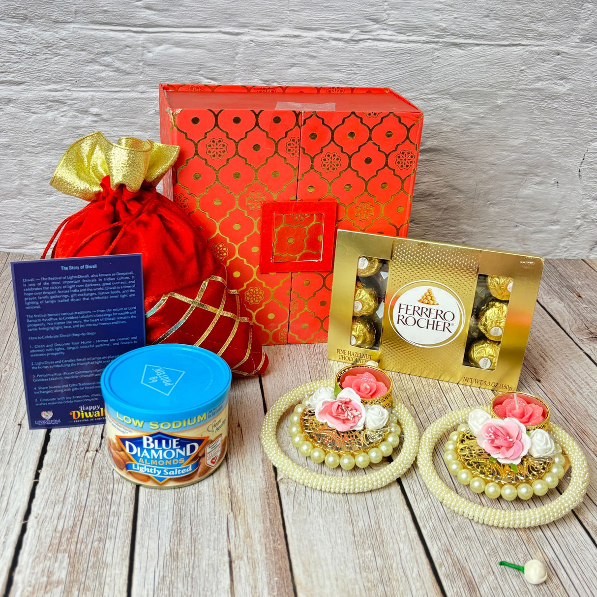 Festive Diwali gift hamper with chocolates, almonds, decorative candles, and traditional accessories