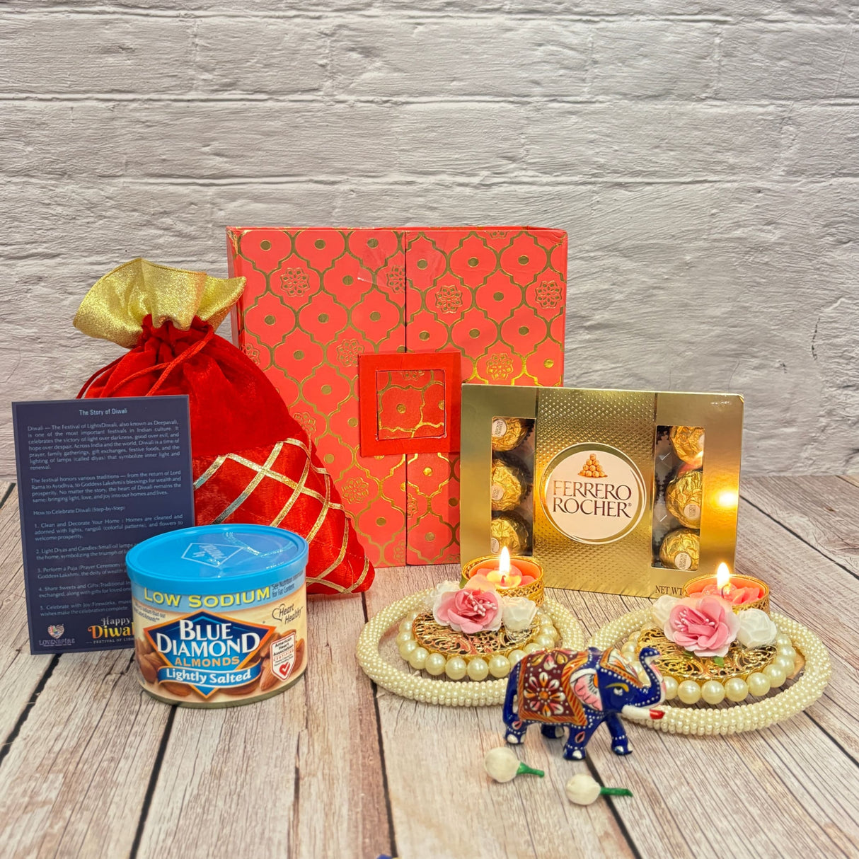 Festive Diwali gift hamper with Ganesha elephant statue, pearls, candles, chocolates
