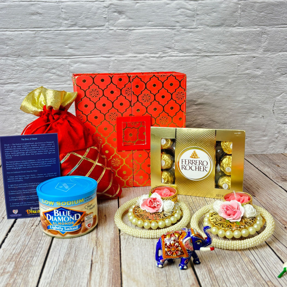 Festive Diwali gift hamper with sweets, nuts, decorative items, and Ganesha statue