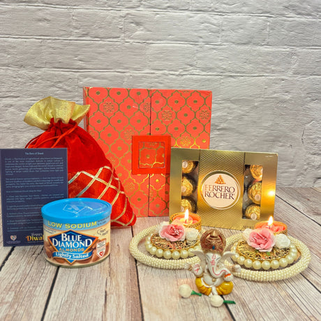 Festive Diwali gift hamper with chocolates almonds candles Ganesha idol and decorative items