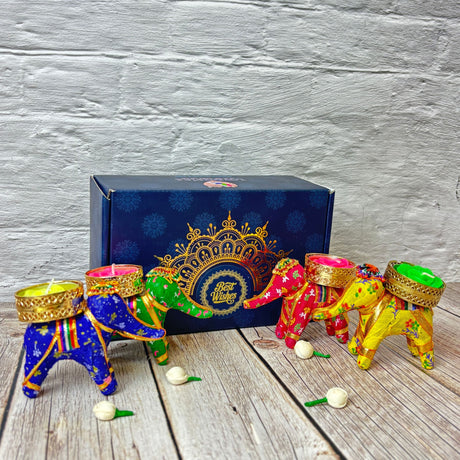 Colorful elephant-shaped tea light holders in decorative gift box for Diwali celebration