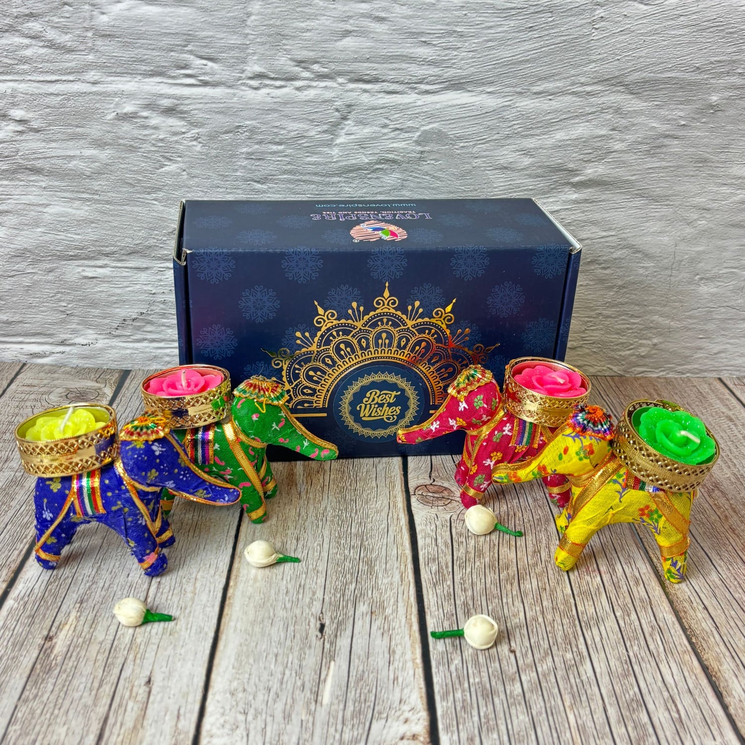 Colorful decorative elephant figurines holding candles for Diwali celebration