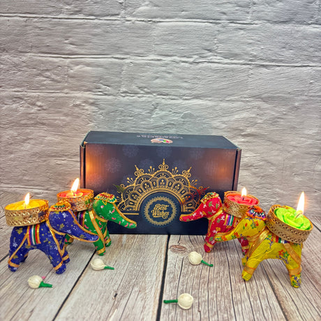 Colorful elephant-shaped tealight candle holders with lit candles for Diwali celebrations