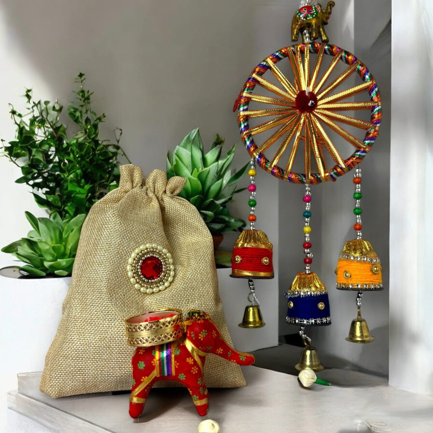 Decorated burlap gift bag with elephant design and wind chime for festival celebrations