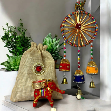 Decorated burlap gift bag with elephant design and wind chime for festival celebrations
