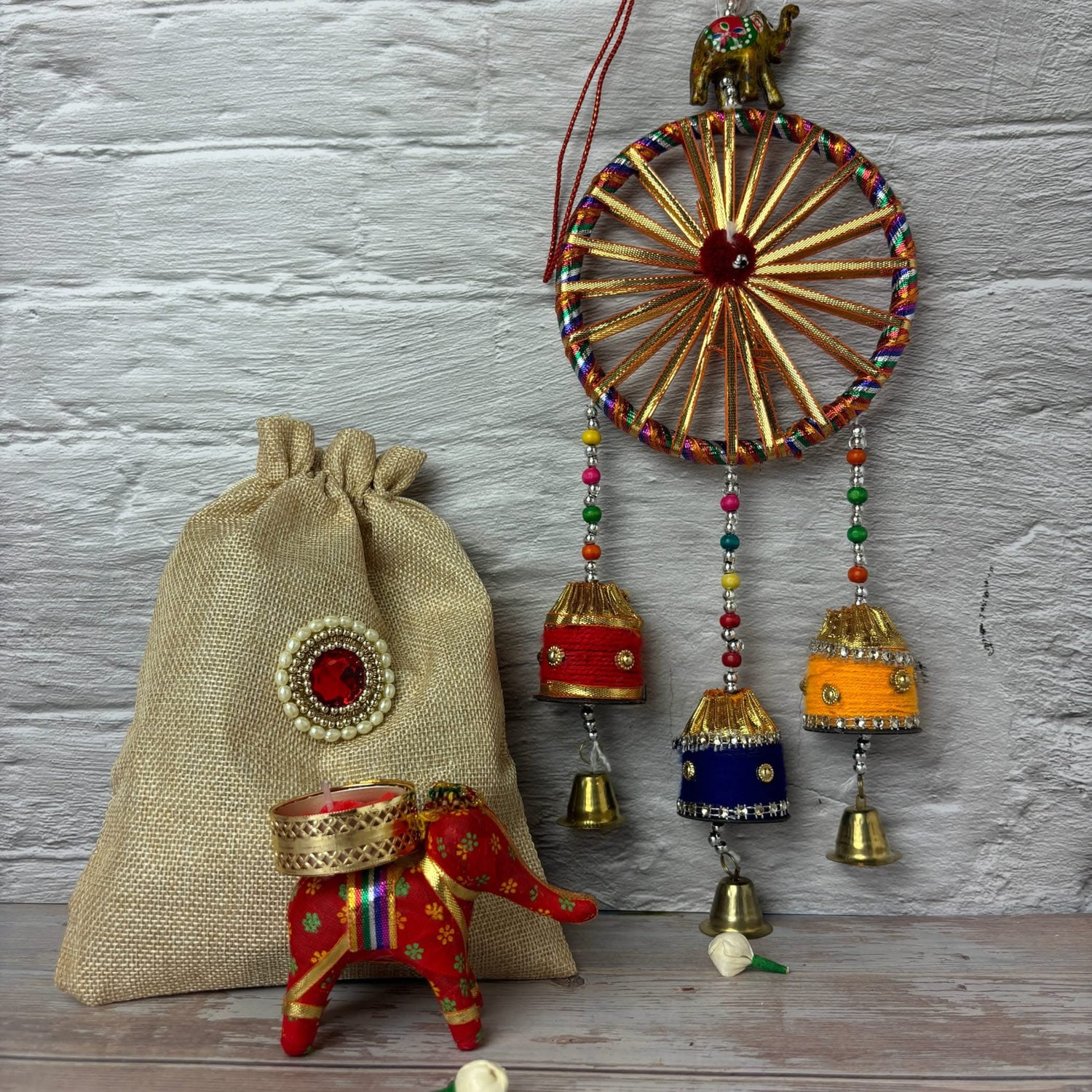 Handcrafted Indian decorations including jute potli bag and elephant candle holder