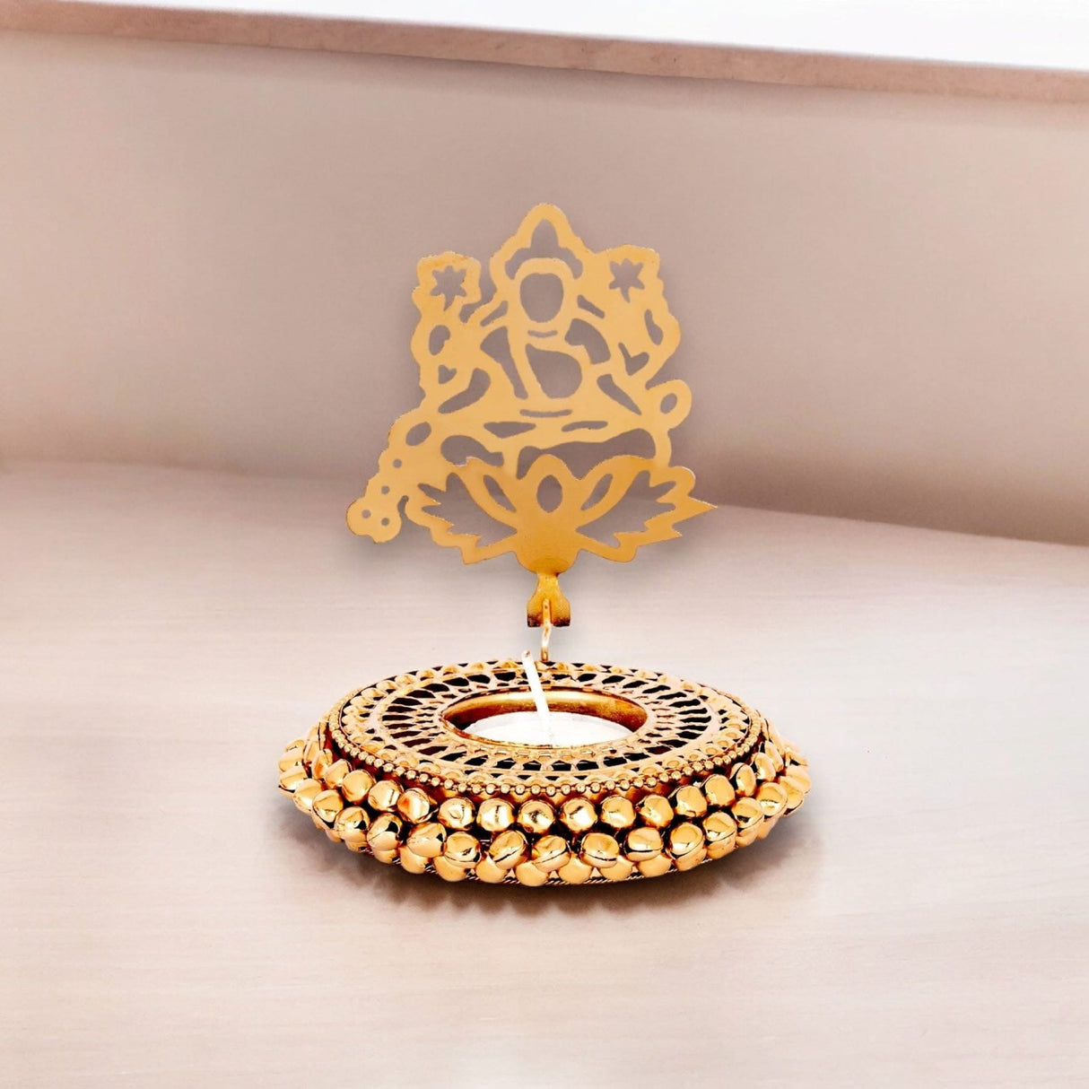 Ornate gold candle holder with deity cutout for Diwali and Indian Festival celebrations
