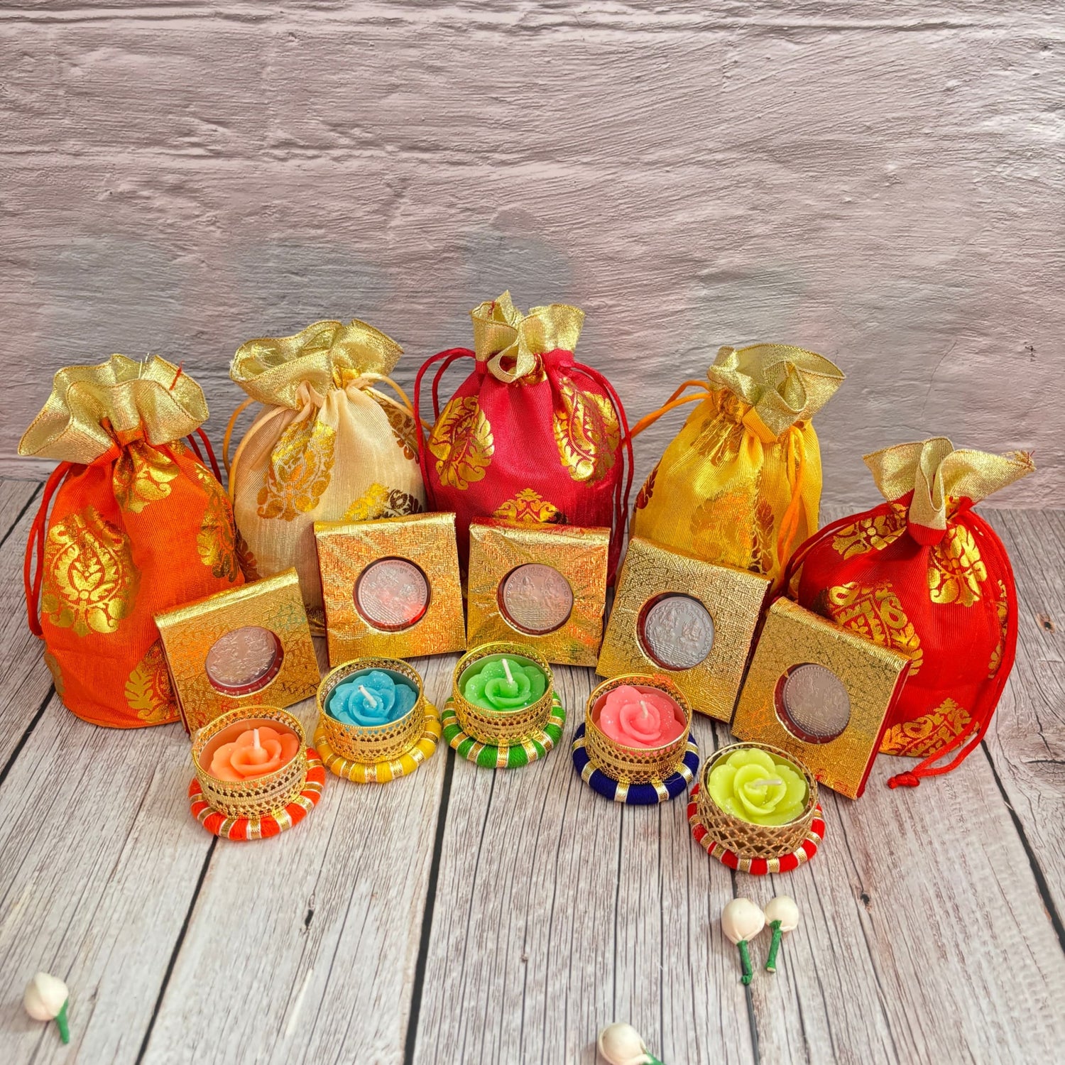 Colorful drawstring pouches with decorative candles for Diwali festival gifting