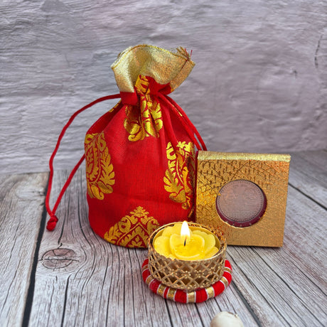 Red and gold Brocade Potli Bag with Laxmi Ganesh Coin and Yellow Candle for Diwali