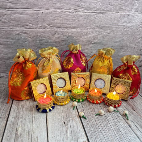 Colorful drawstring pouches and decorative tea light candles for Diwali celebration