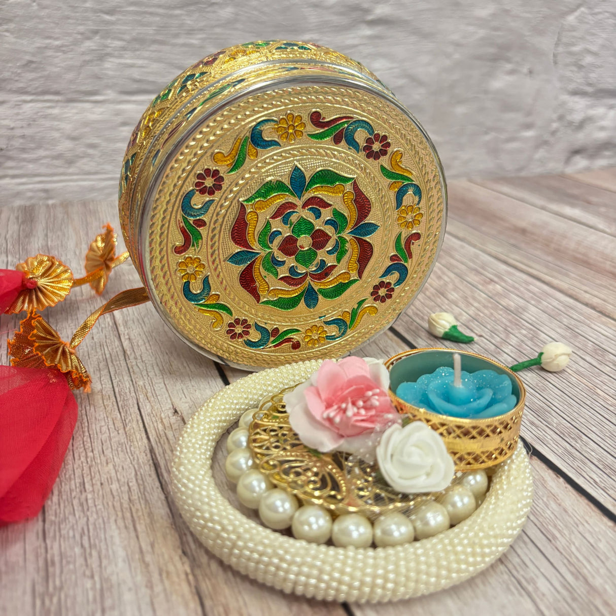 Decorative gold-colored metal box with colorful enamel floral patterns for Diwali gifts
