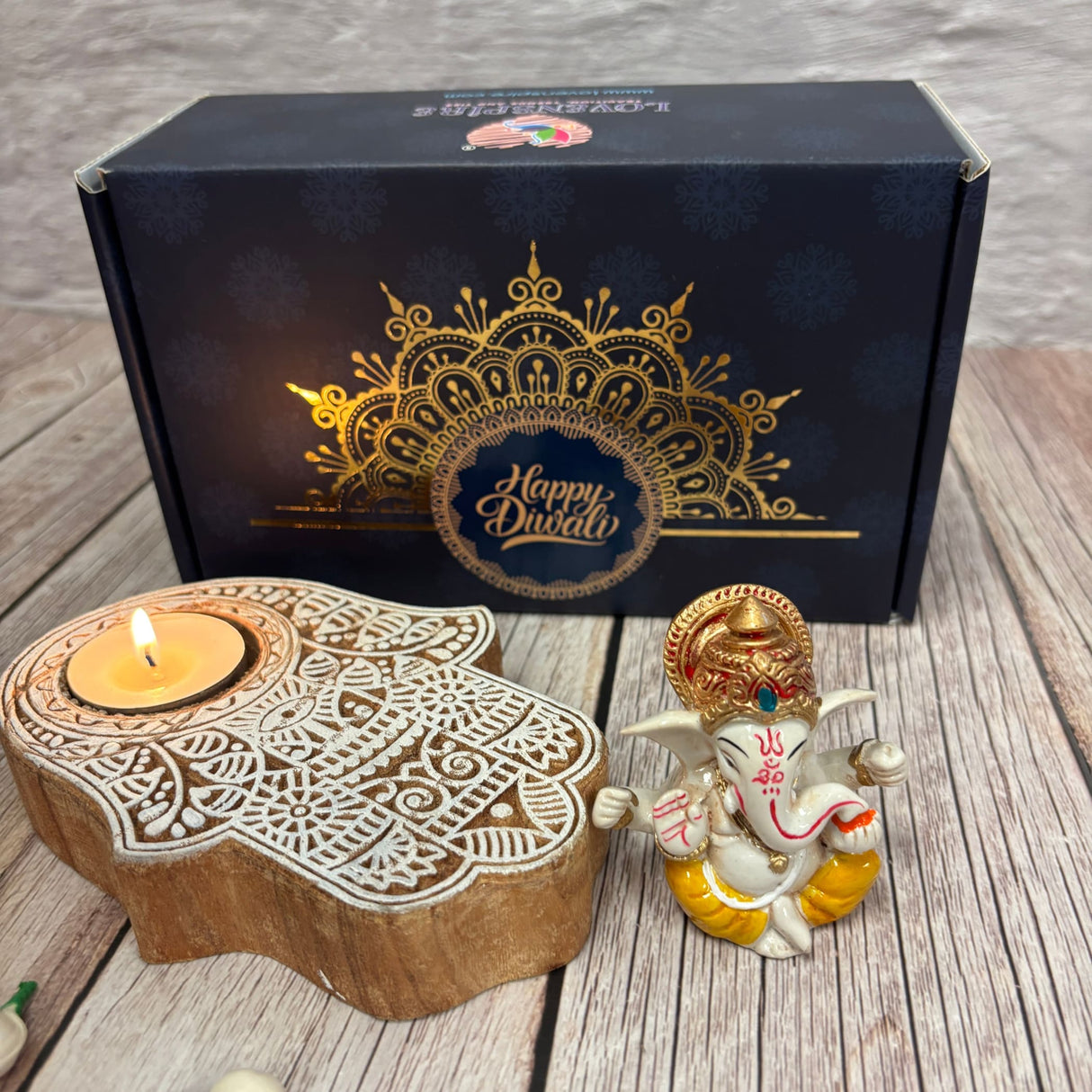 Festive Diwali gift box with Ganesha idol and Hamsa hand tea light holder for celebrations
