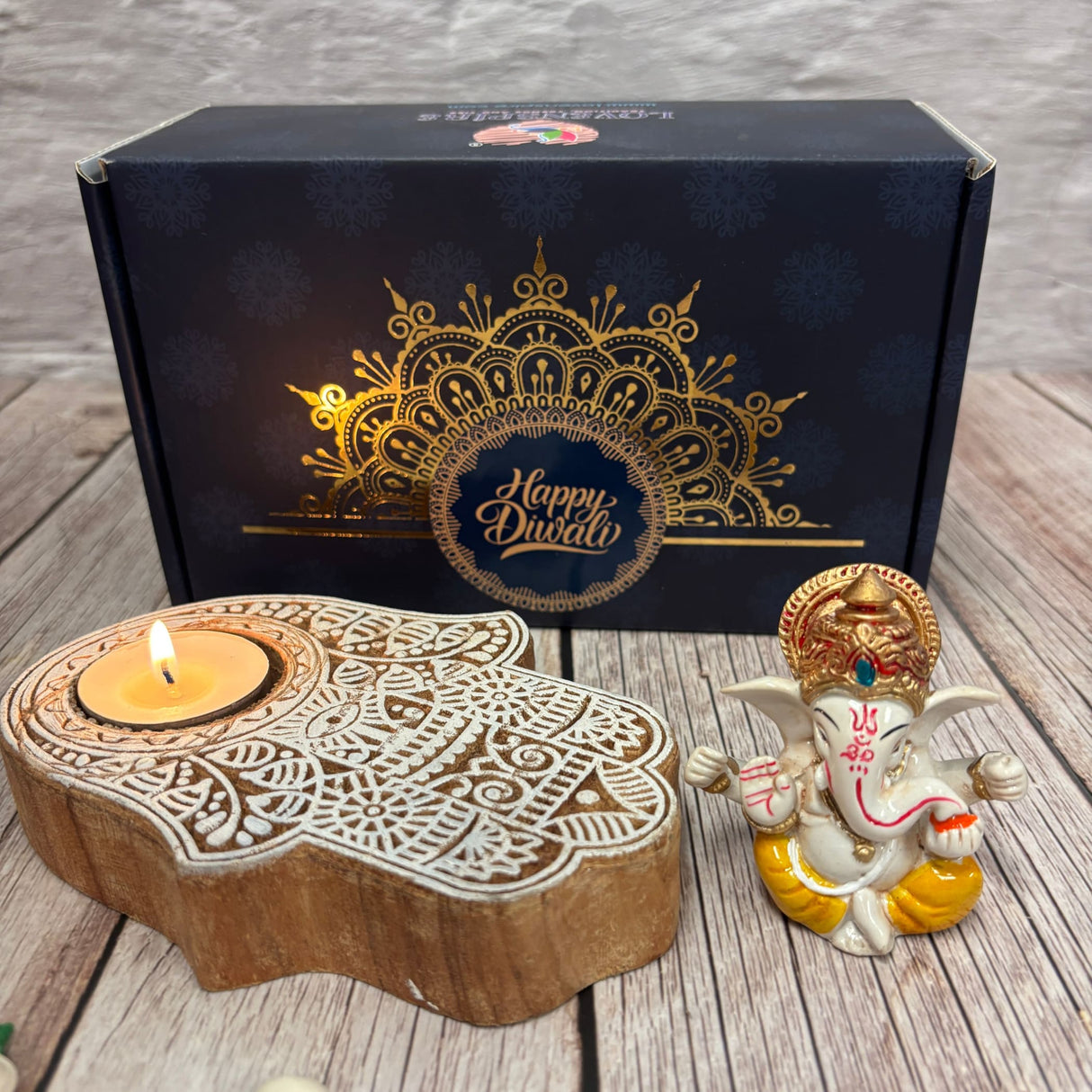 Diwali gift set with Ganesha idol, wooden Hamsa hand tea light holder, and decorative box