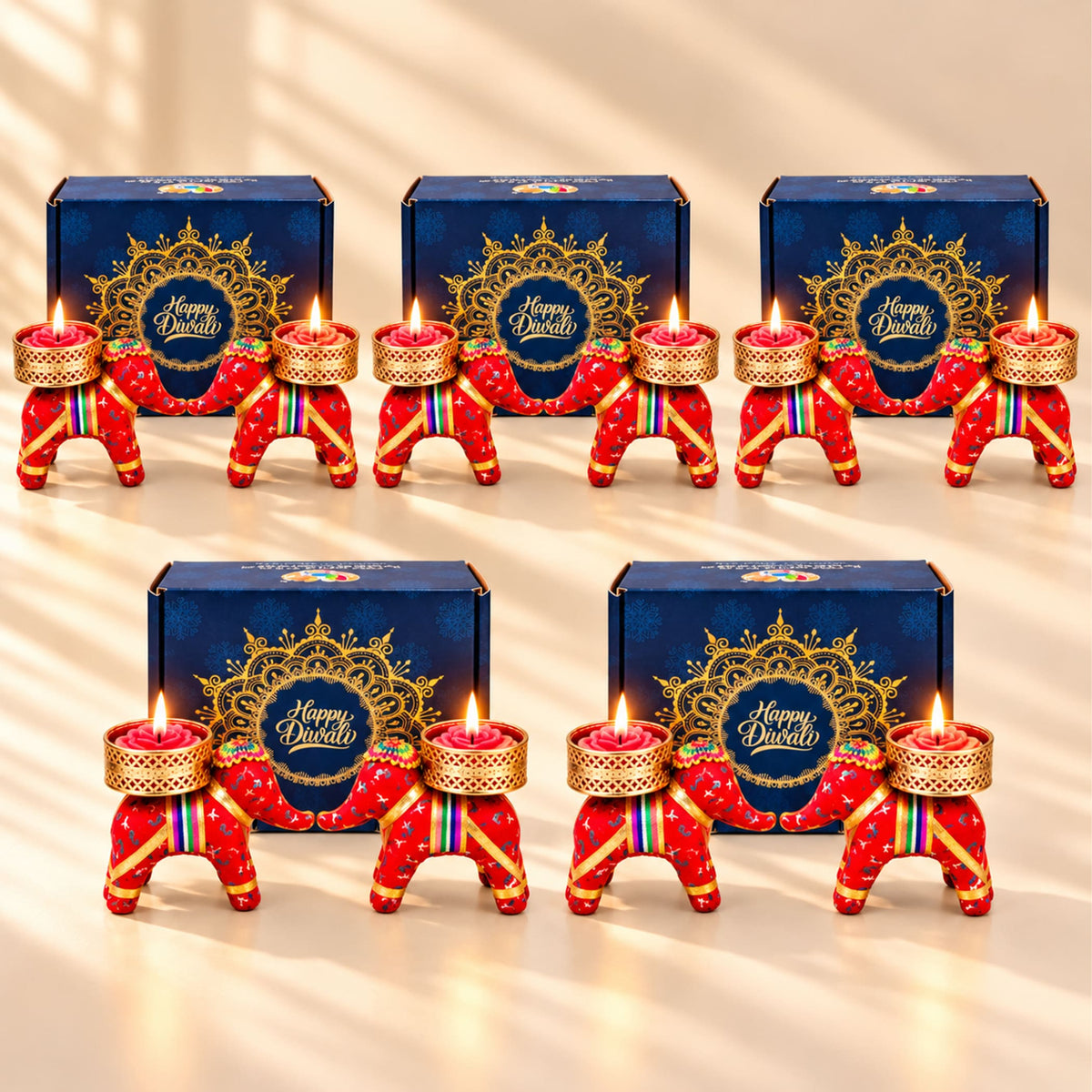 Red elephant-shaped handmade Diwali candle holders with gold accents and rainbow stripes for festive gifting
