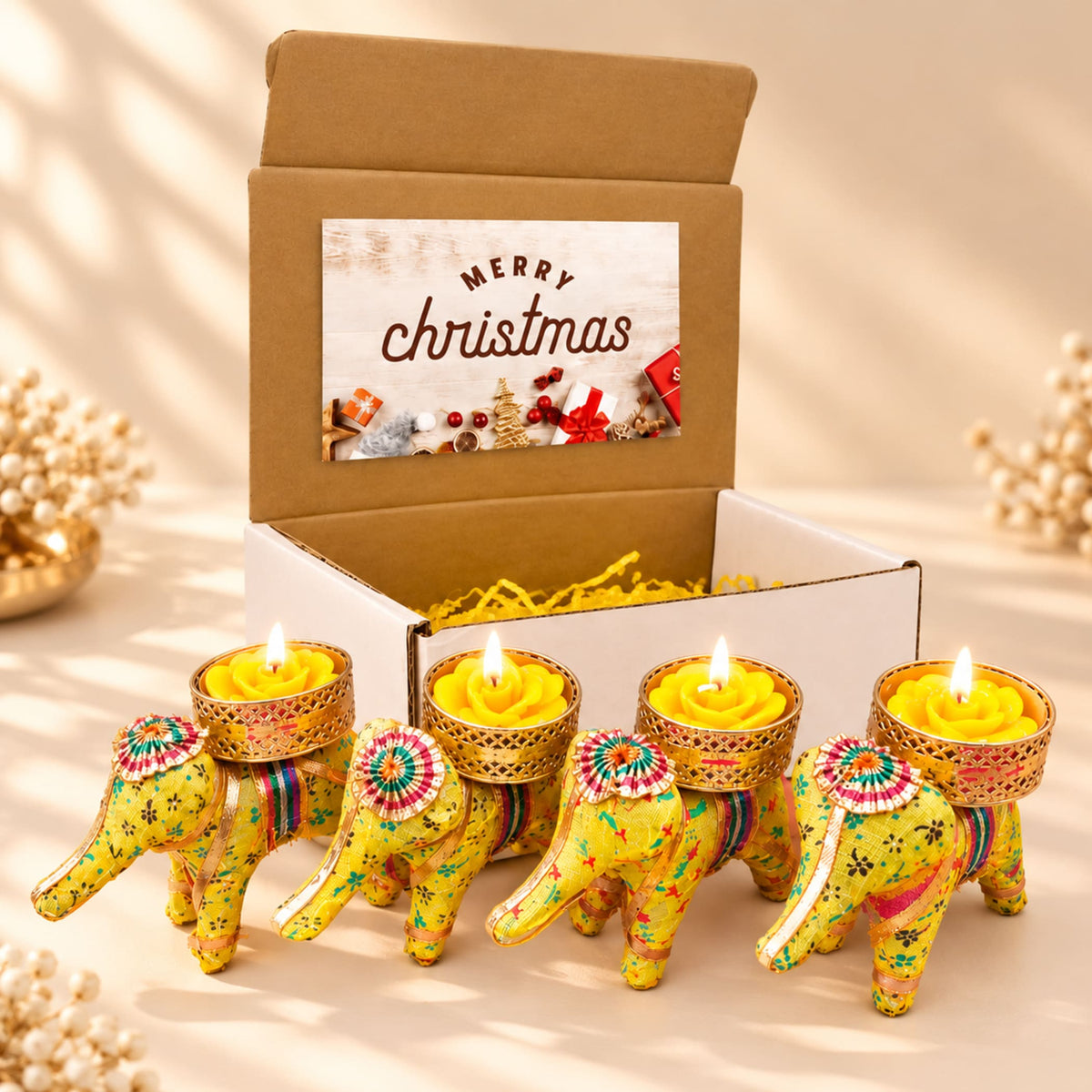 Yellow elephant-shaped tealight candle holders with intricate gold and multicolored patterns for festive gifting