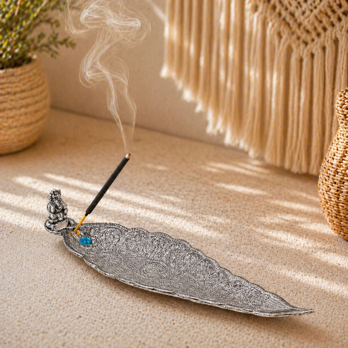 Silver leaf-shaped elephant incense stick and cone holder with intricate filigree and a blue gemstone accent for mess free use