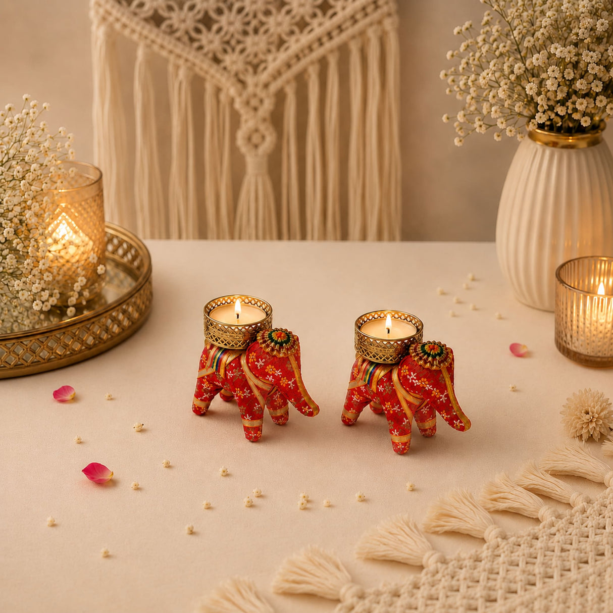Two vibrant red elephant-shaped candle holders with intricate gold and green patterns for diwali and home decor