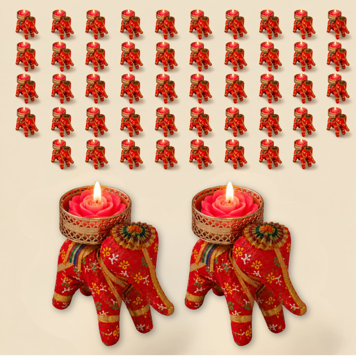 Red elephant-shaped tea light candle holders with gold floral patterns cradling pink rose wax candles for festive decor