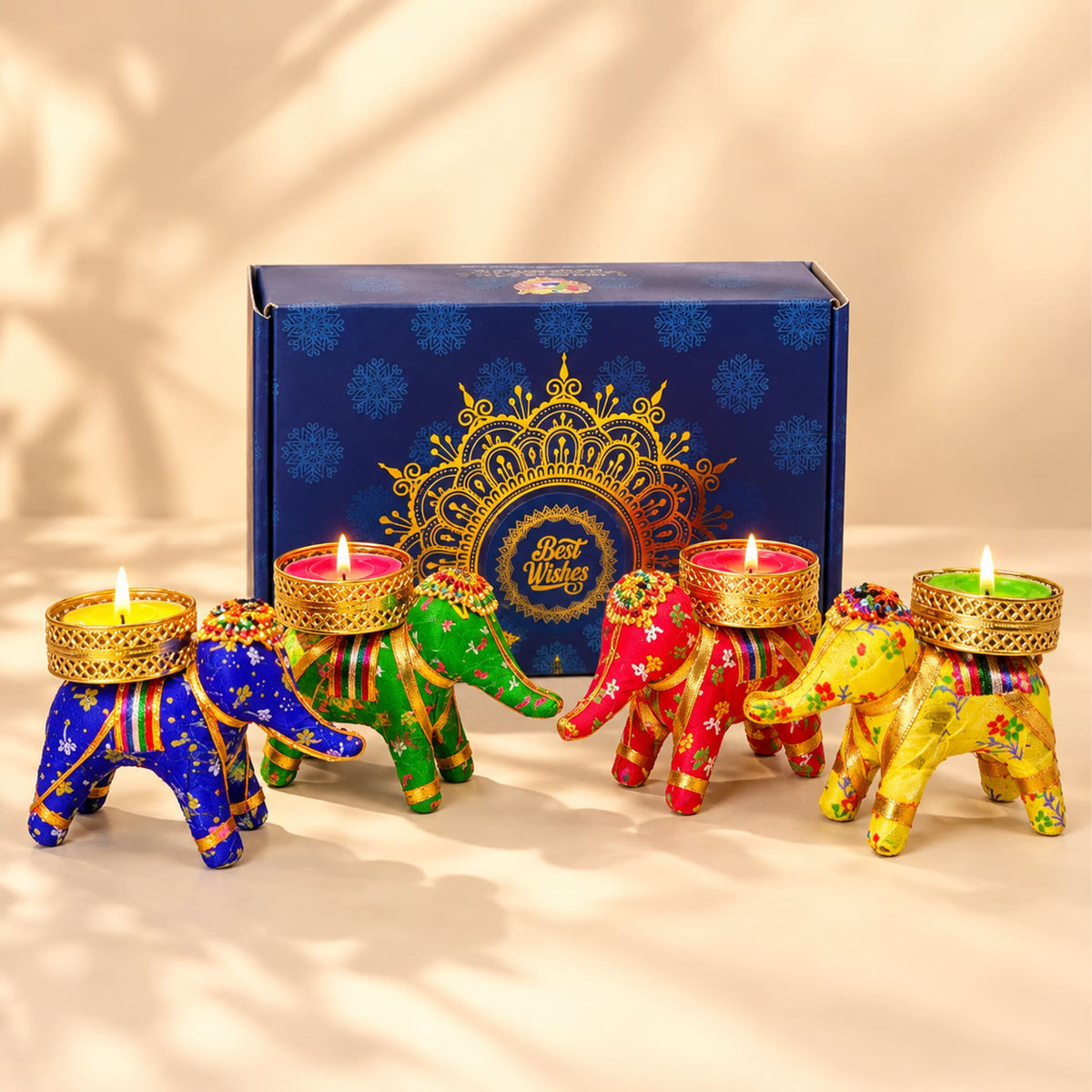 Colorful elephant-shaped tealight candle holders in blue green red and yellow with gold-trimmed bases for diwali gifts
