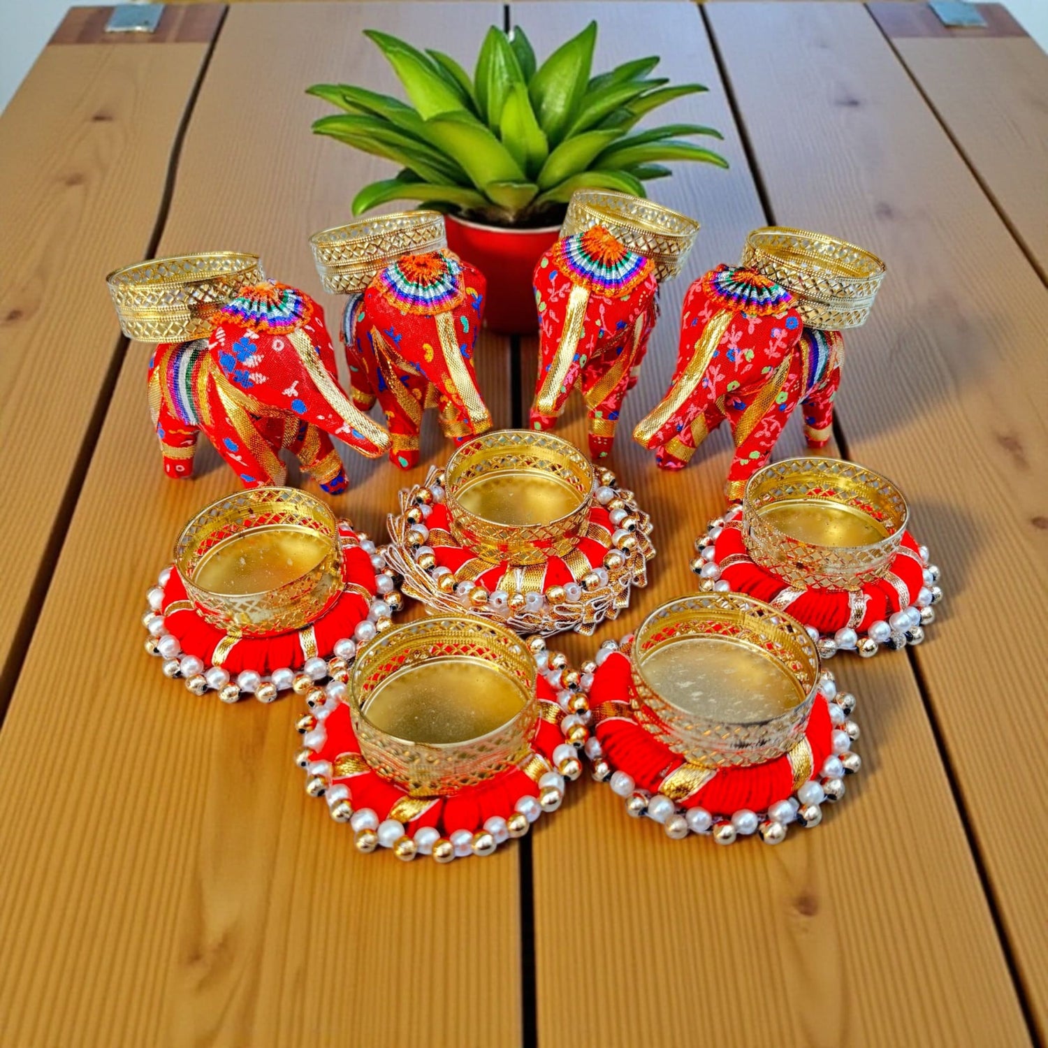 Red and gold elephant and circular decorative candle holders for Diwali and festive decor