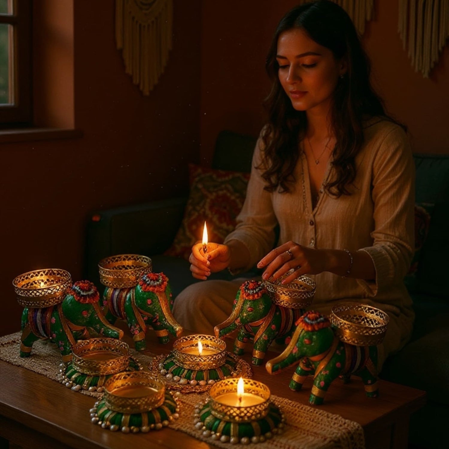 Decorative elephant-shaped candle holders and tealight holders in green and gold with intricate patterns
