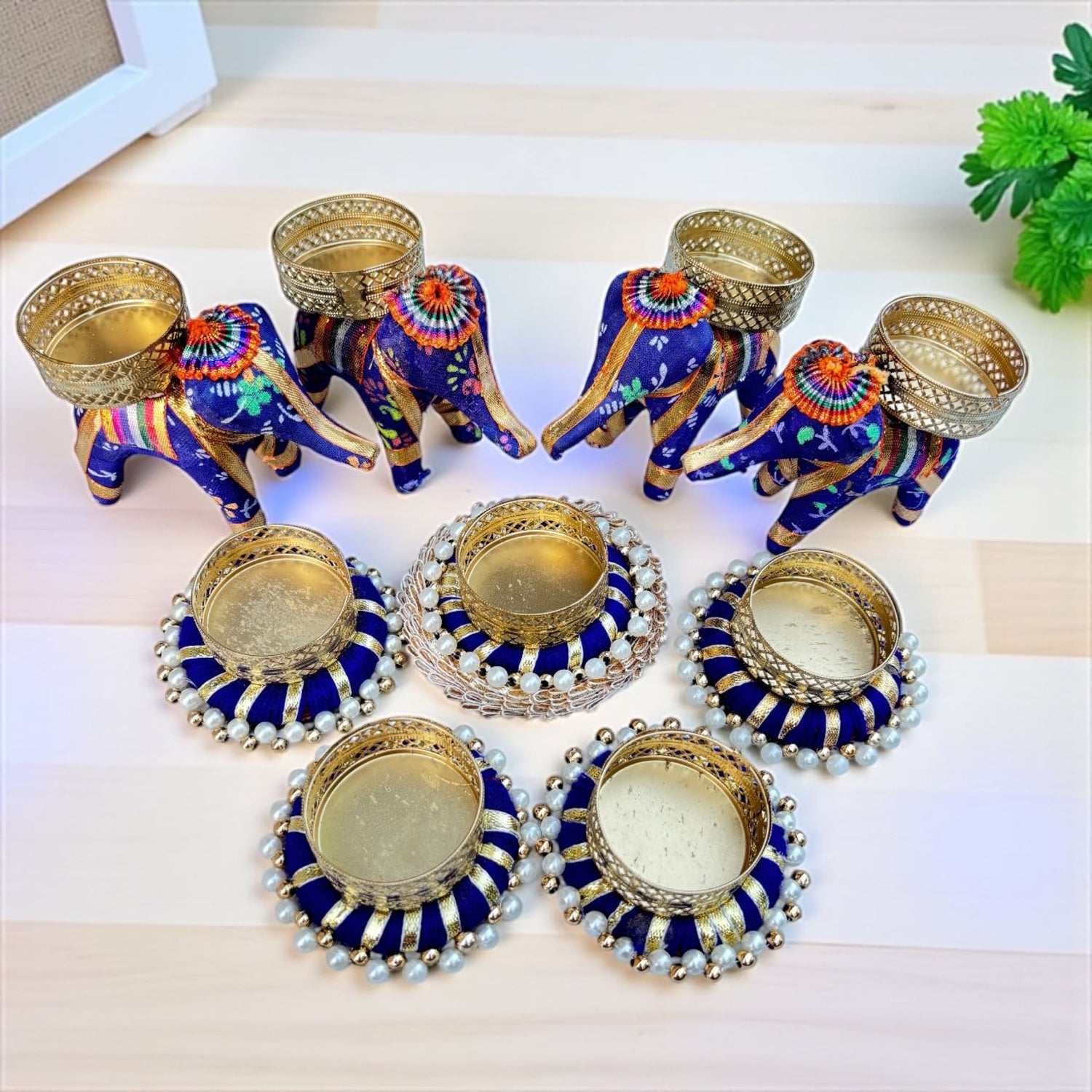 Blue and gold ornate elephant-shaped and round candle holders for Diwali and festive decor