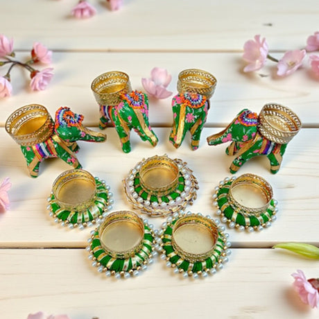 Green elephant and round gold-accented tealight candle holders for festive home decor