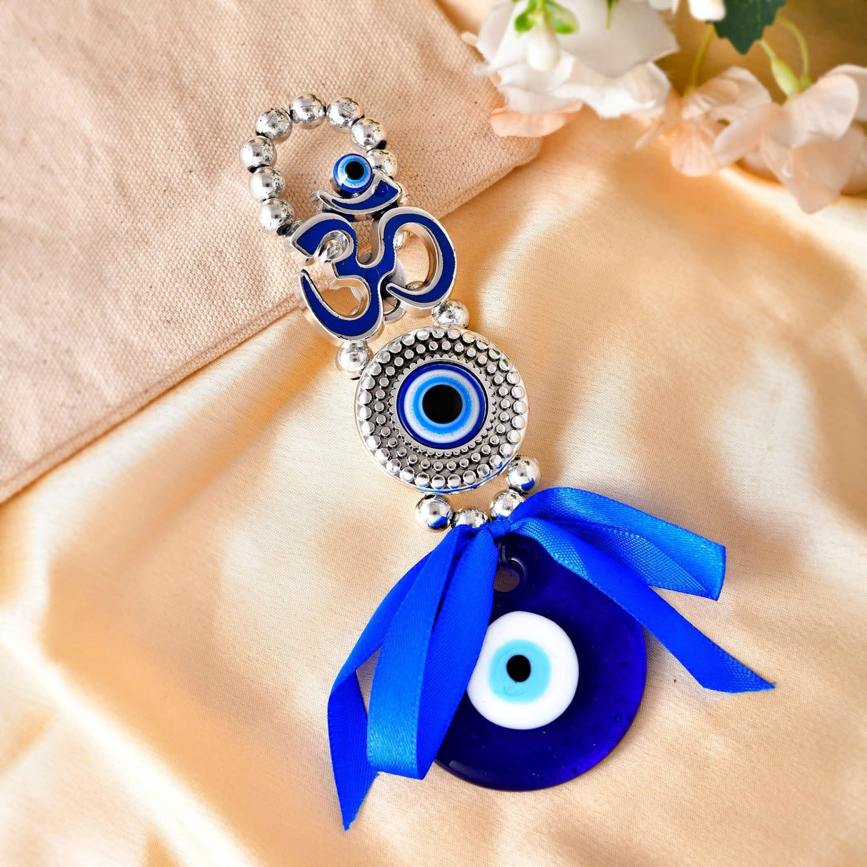 Blue and silver Om Evil Eye charm for good luck and protection in home or car decor