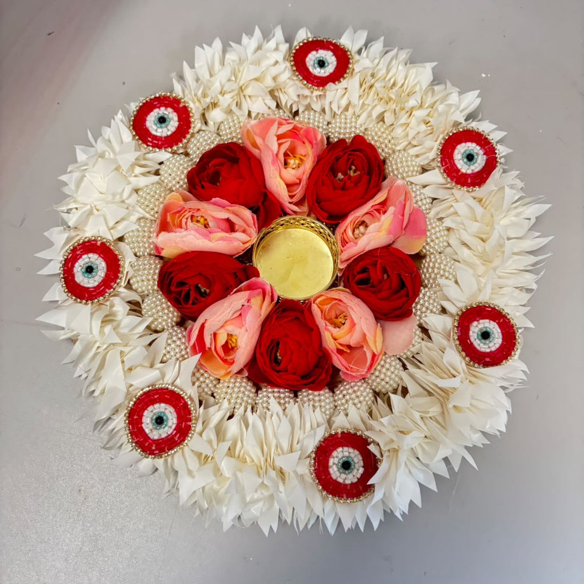 Decorative floral rangoli mat tealight candle holder with red and pink roses gold holder white petals for festive décor