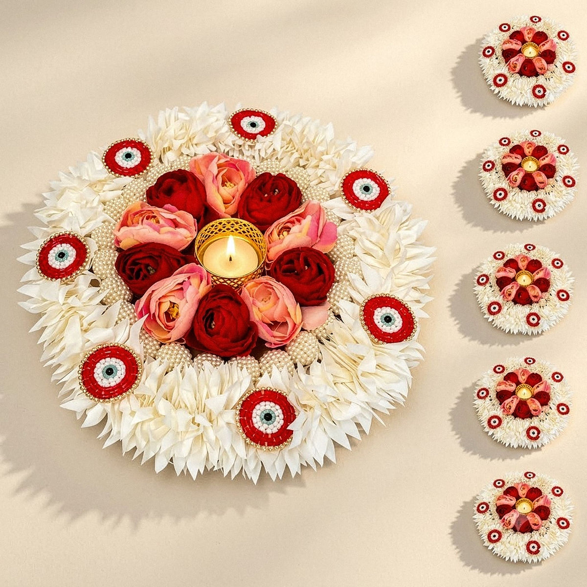 Decorative floral rangoli mat tealight candle holder with a golden diya and white pink rose accents for home décor