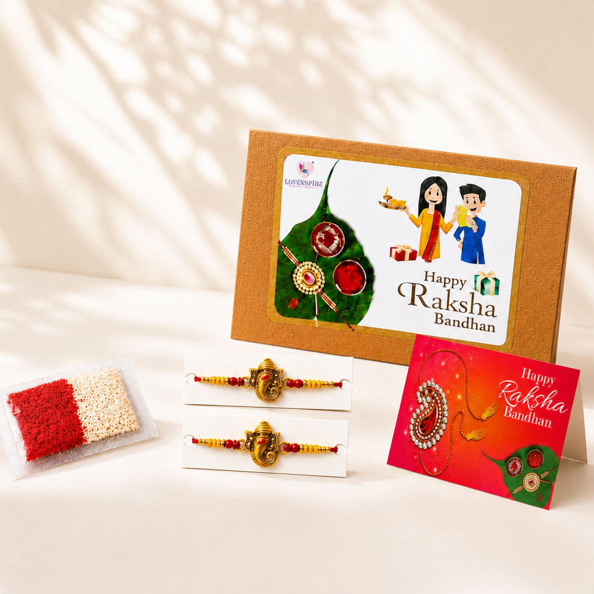 Designer ganesha rakhi set with gold-colored ganesha charm and red and yellow beads for brother and bhabhi