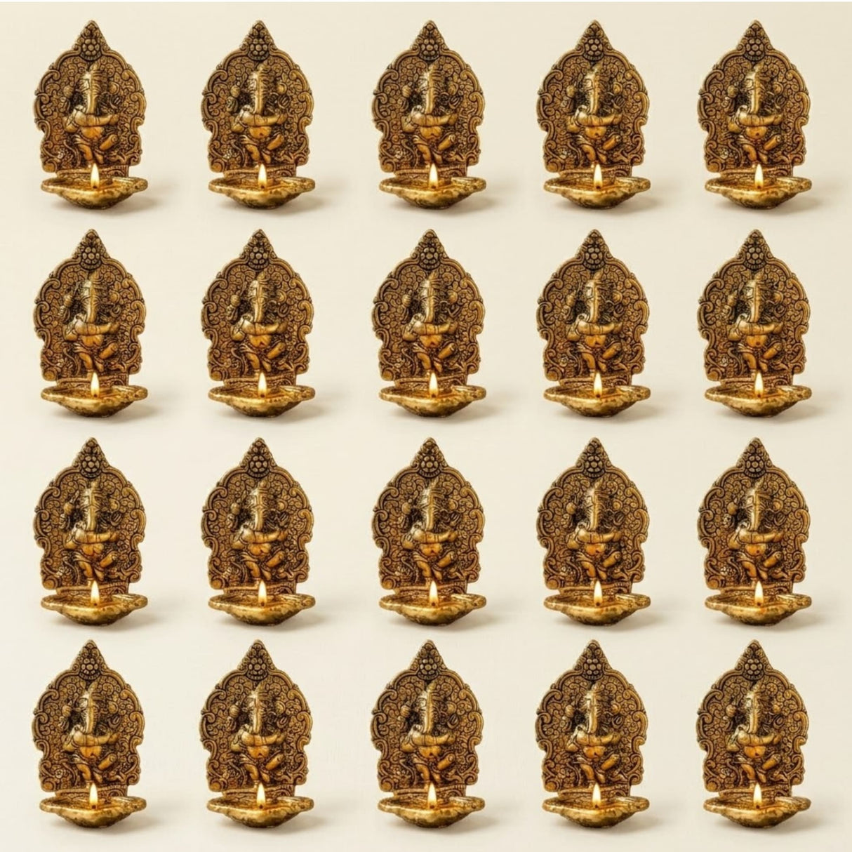 Golden brass ganesha diya oil lamp with intricate carvings and small flame for puja and diwali home decor