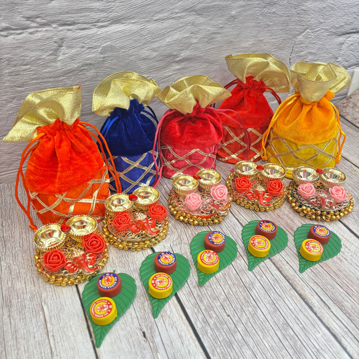 Colorful velvet drawstring pouches and decorative gift sets for Ganesha Puja celebrations