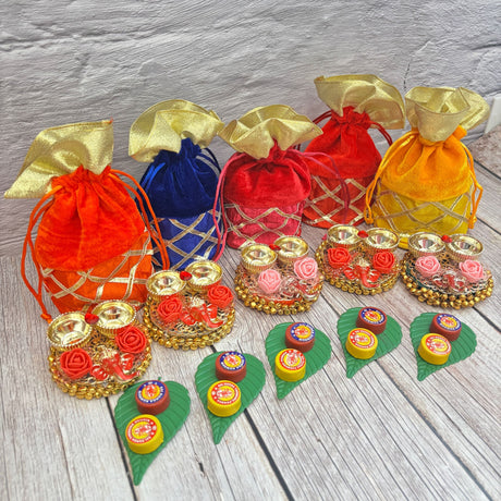 Colorful velvet drawstring pouches and decorative gift sets for Ganesha Puja celebrations