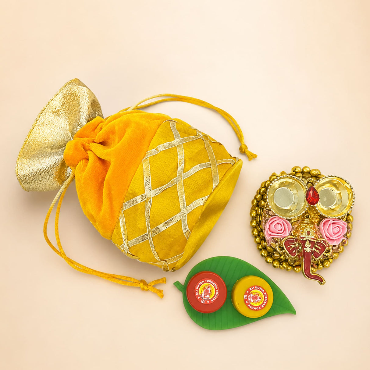 Golden pineapple-shaped drawstring pouch with textured metallic gold top and silver lattice for ganesh chaturthi gifts
