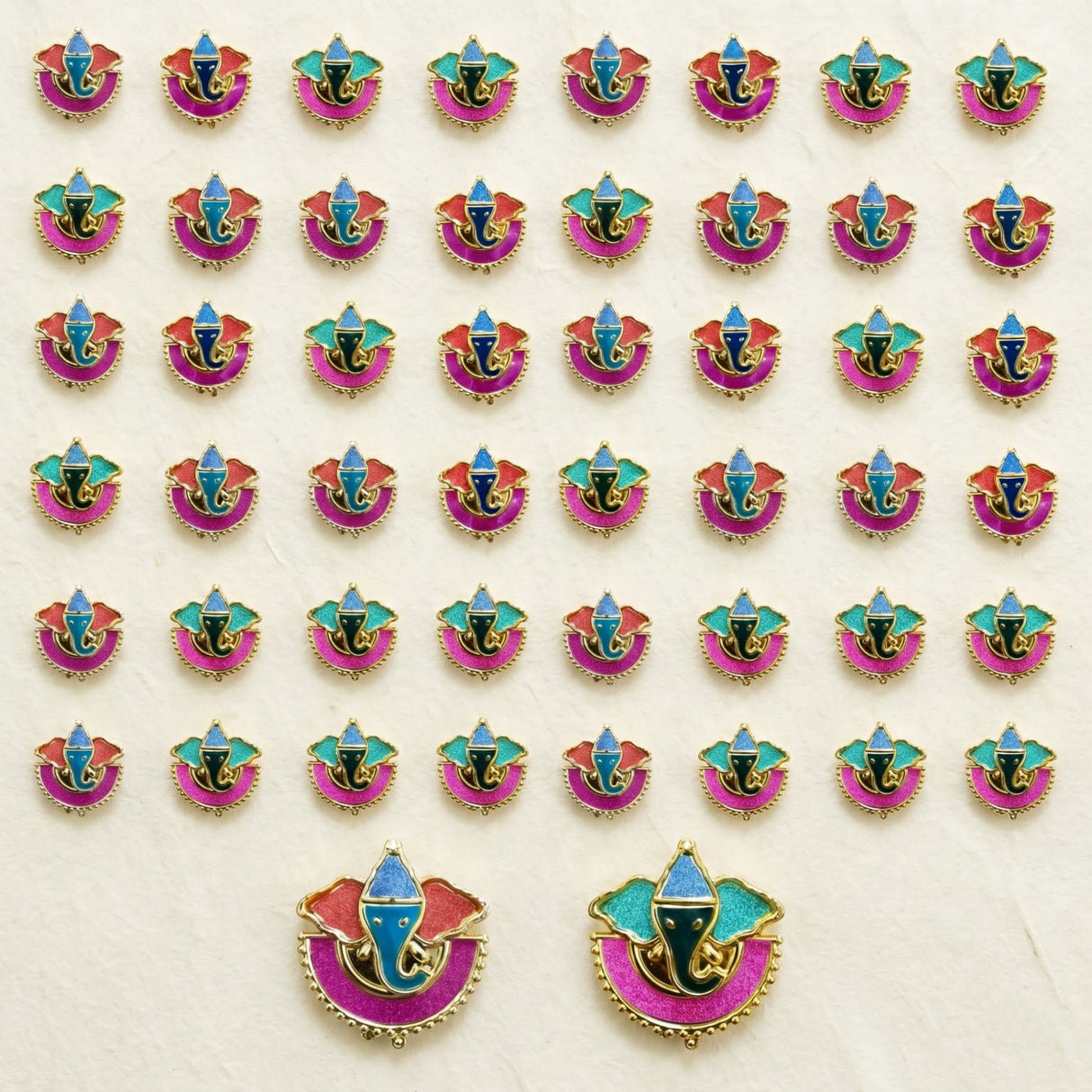 Colorful enamel ganesha decorative pins with gold-tone edges in pink red teal and blue for indian festival favors