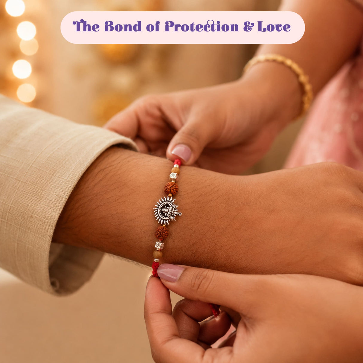Designer ganesha rakhi gift hamper featuring a silver sun-themed rakhi with red and brown beads for brother and bhabhi