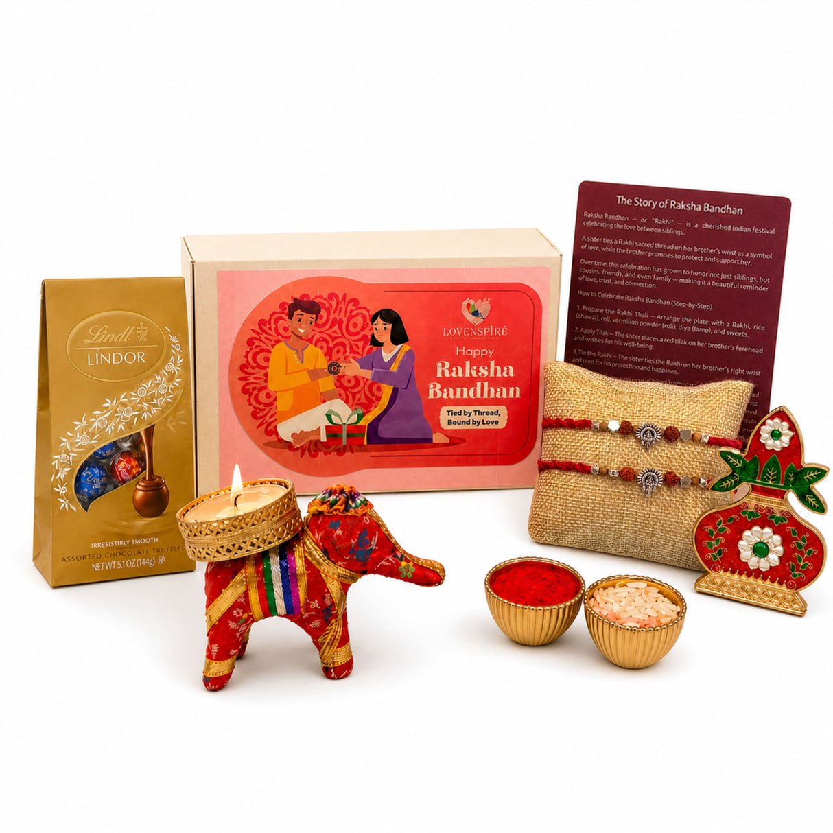 A vibrant red designer ganesha figurine with colorful embroidery and golden bowl in a rakhi gift hamper for brother and bhabhi