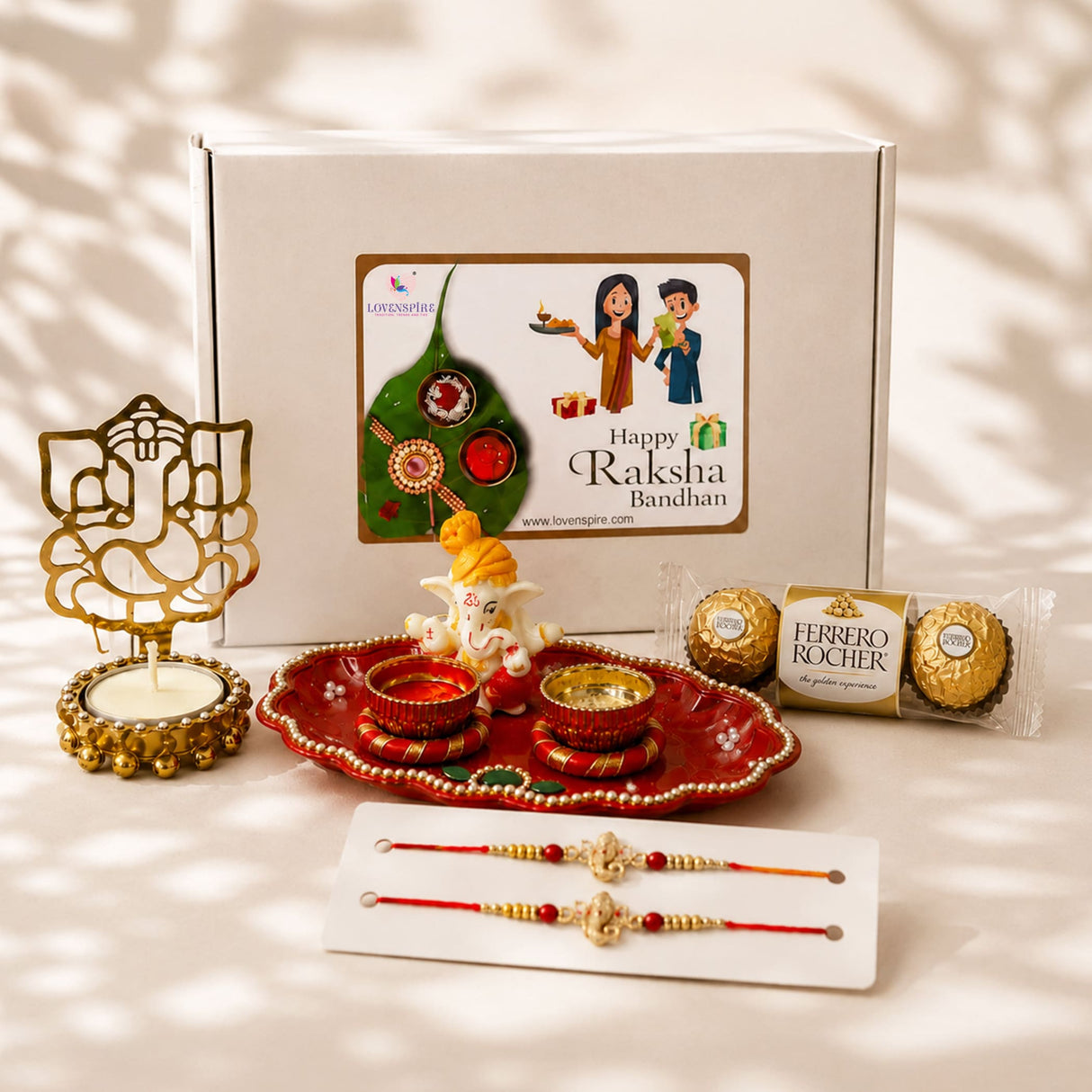 Red ornate tray with gold trim and beads holding two golden bowls with red liquid in raksha bandhan gift hamper set