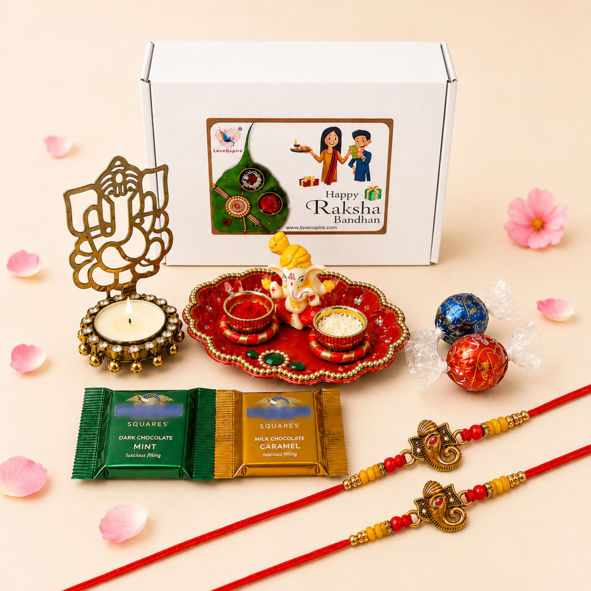 Red and gold ornate tray with small ganesha figurine at center in raksha bandhan ganesha gift hamper set for bhaiya bhabhi