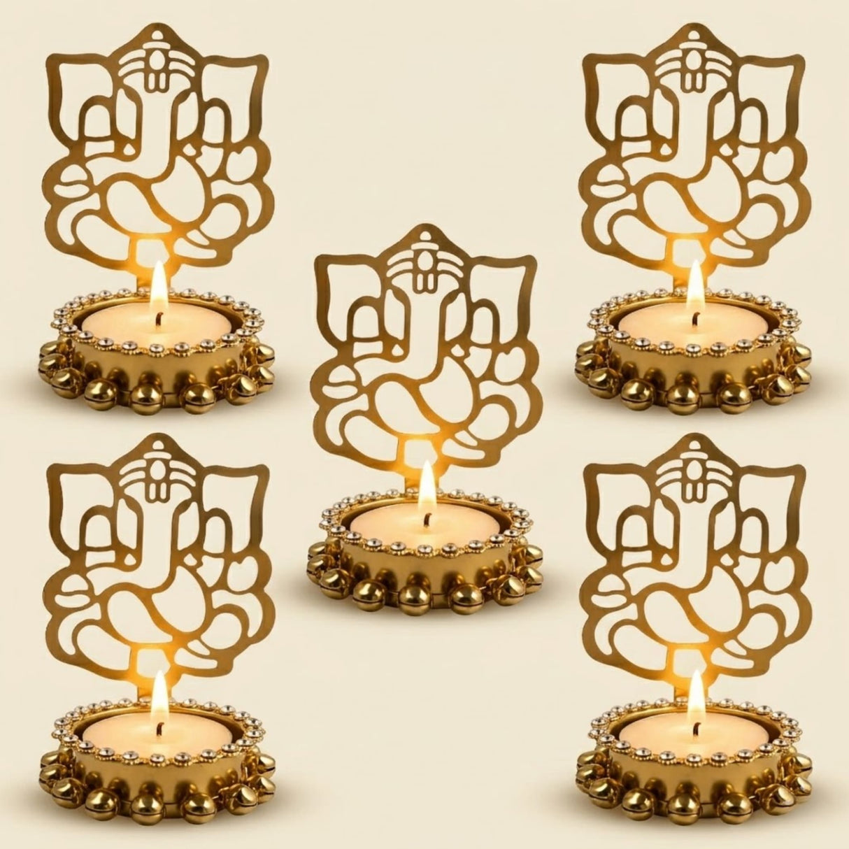 Golden ganesha tea light candle holders with intricate cut-out designs and beaded edges for diwali decor and gifts