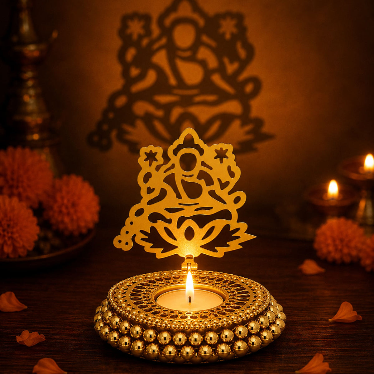 Golden ganesha-themed ghungroo tea light candle holder with intricate cut-out design and beaded base for diwali pooja and decor