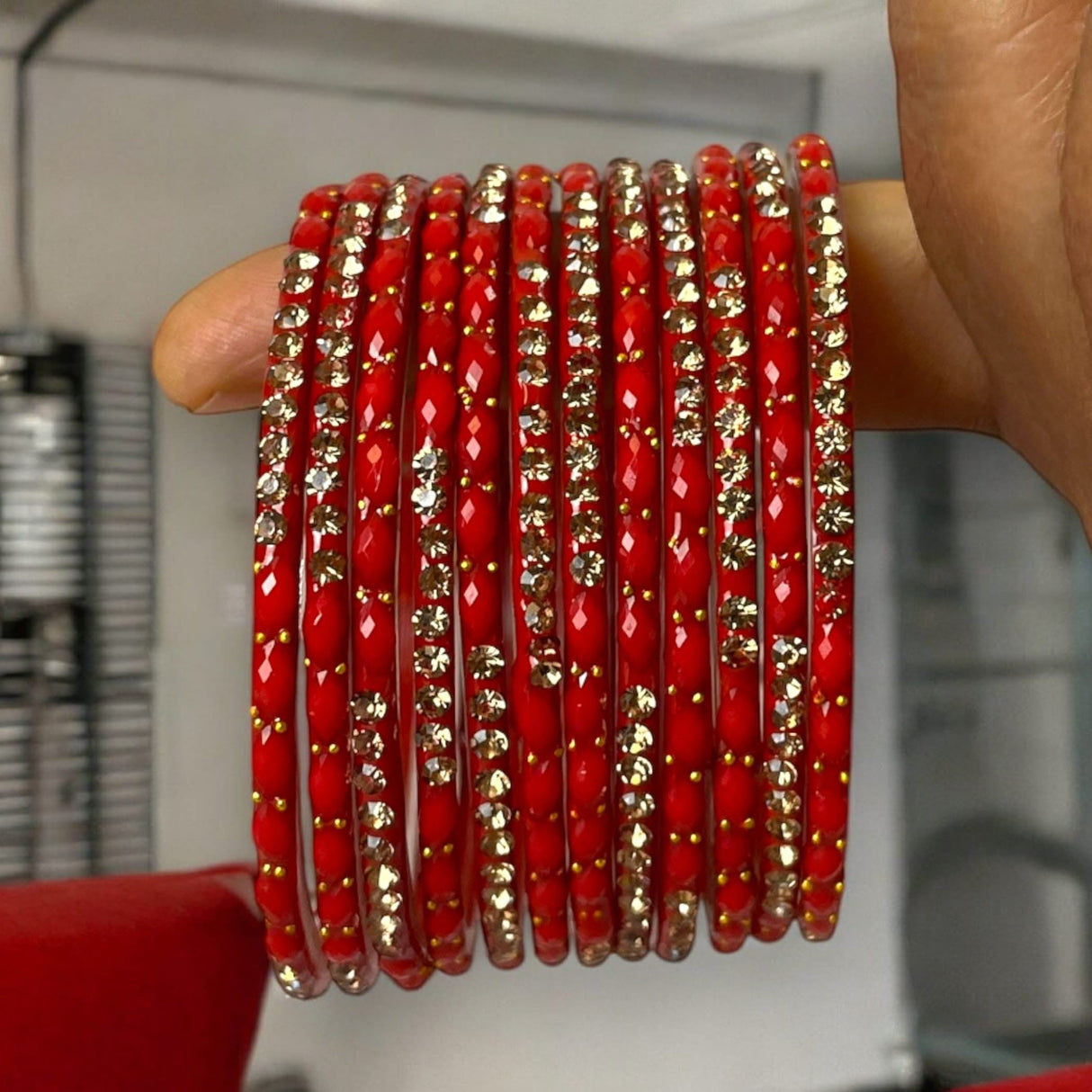 Red and gold embellished glass bangles from Indian jewelry set for weddings and festivals