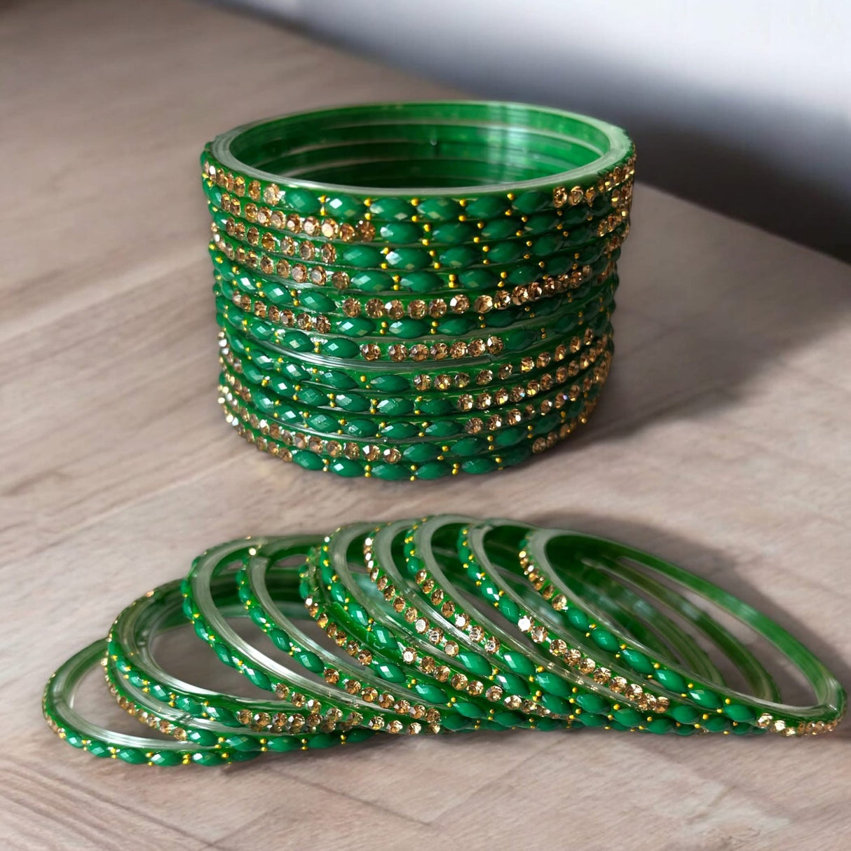 Green and gold glass bangles from Indian jewelry set for weddings and festivals