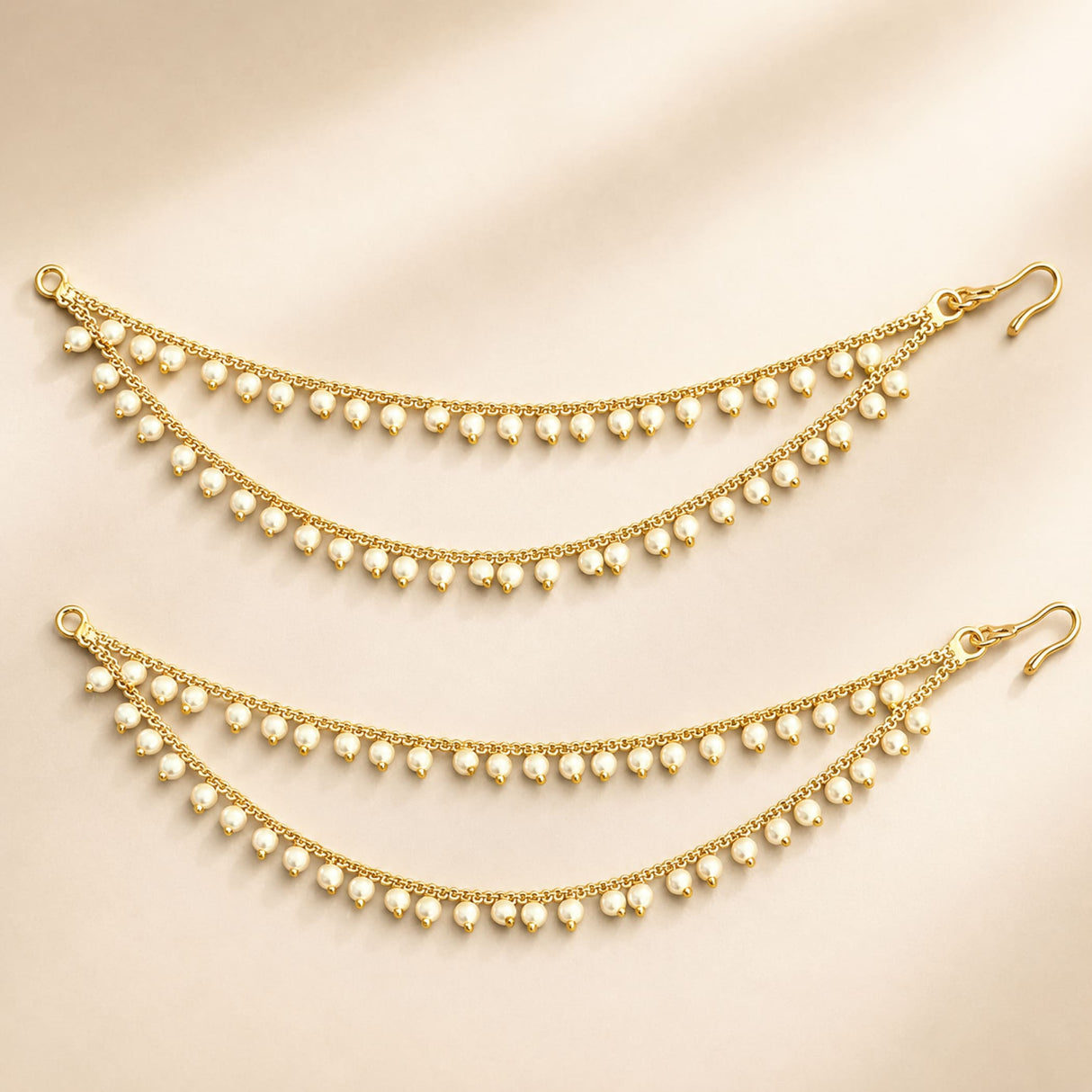 Gold-colored traditional double layer ear chains adorned with small white faux pearls for weddings and festive wear