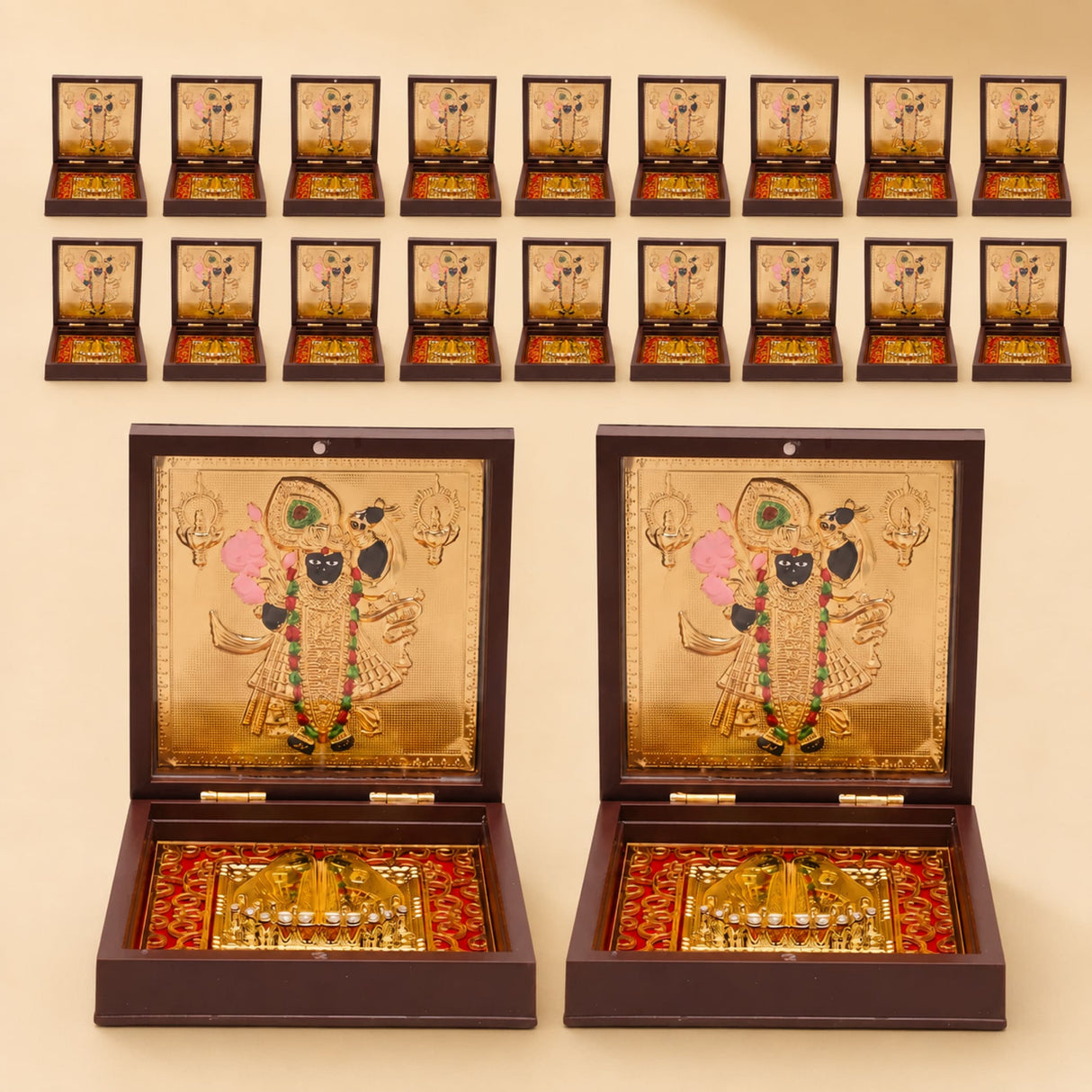 Gold plated shrinath krishna deity figurines in dark brown wooden boxes with red and gold patterned interiors for home temple decor