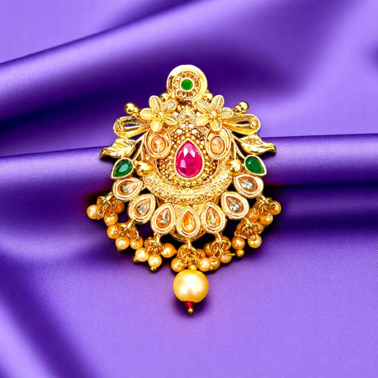 Ornate gold sari brooch with colorful gemstones, traditional Indian wedding jewelry